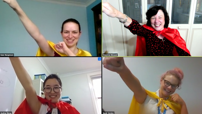 Four women on a Zoom call wearing capes and holding their arm out like a superhero