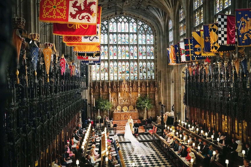 Britain's Prince Harry and Meghan Markle kneel, during their wedding ceremony.