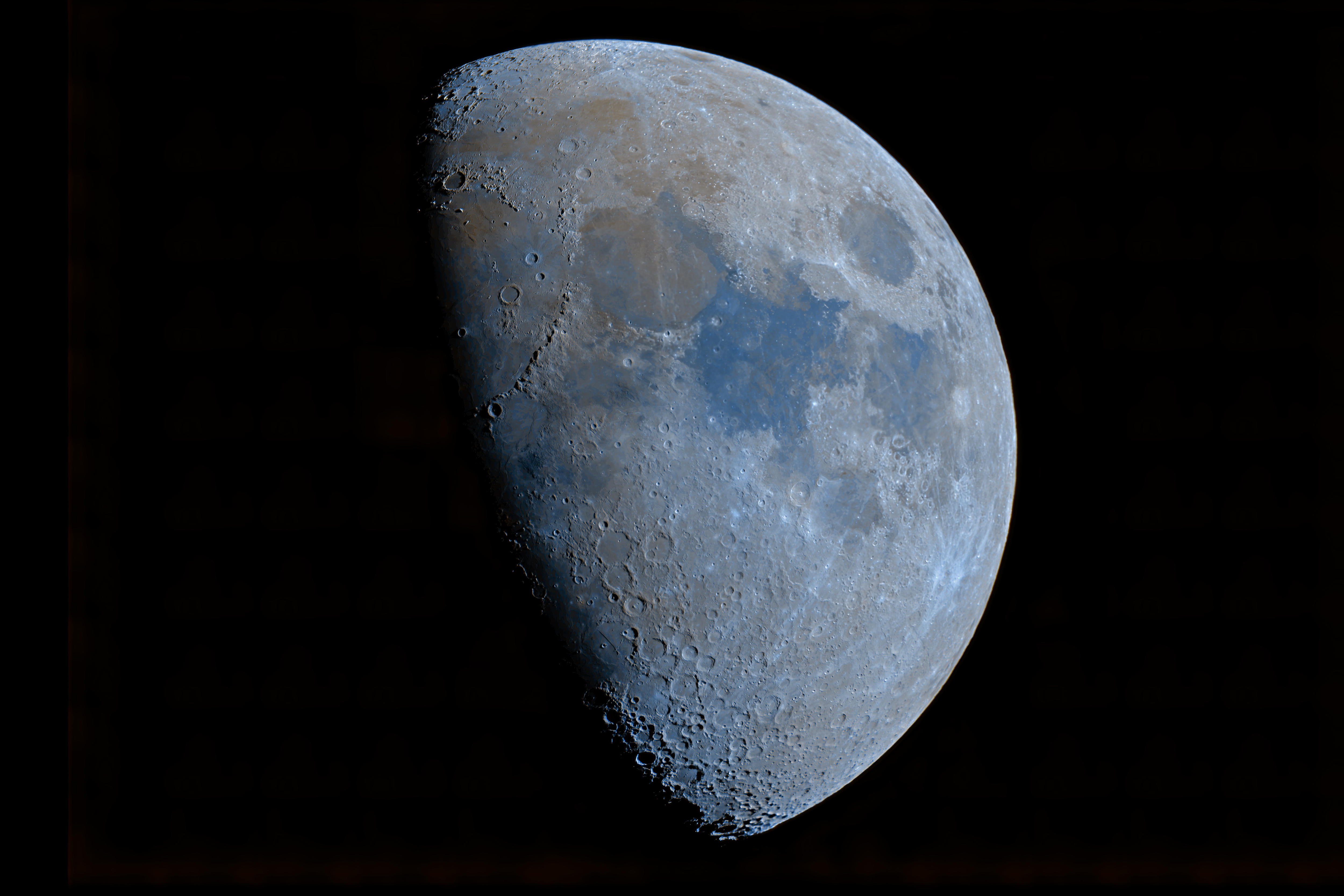 A photograph of the Moon half-obscured by shadows.