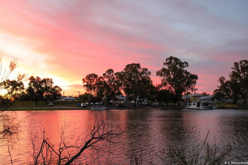 The Darling River in the foreground with a beautiful pink sunset over the small town of Wentworth. 