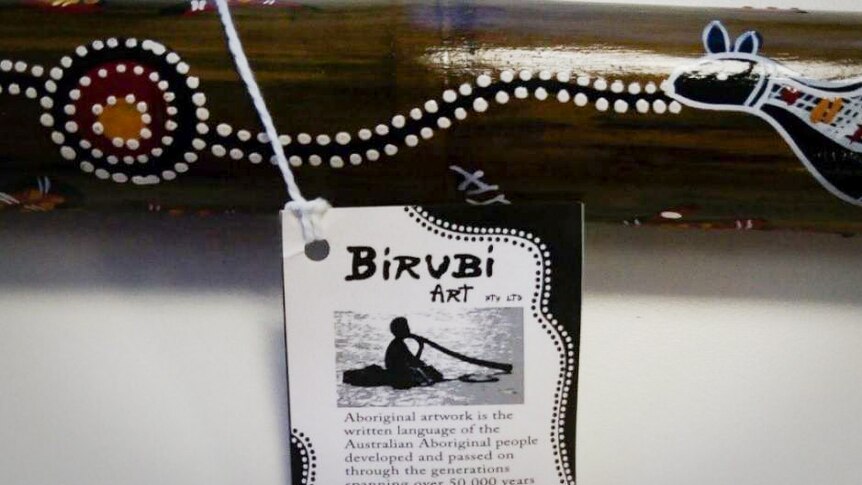 A description tag on a didgeridoo made by Birubi Art.