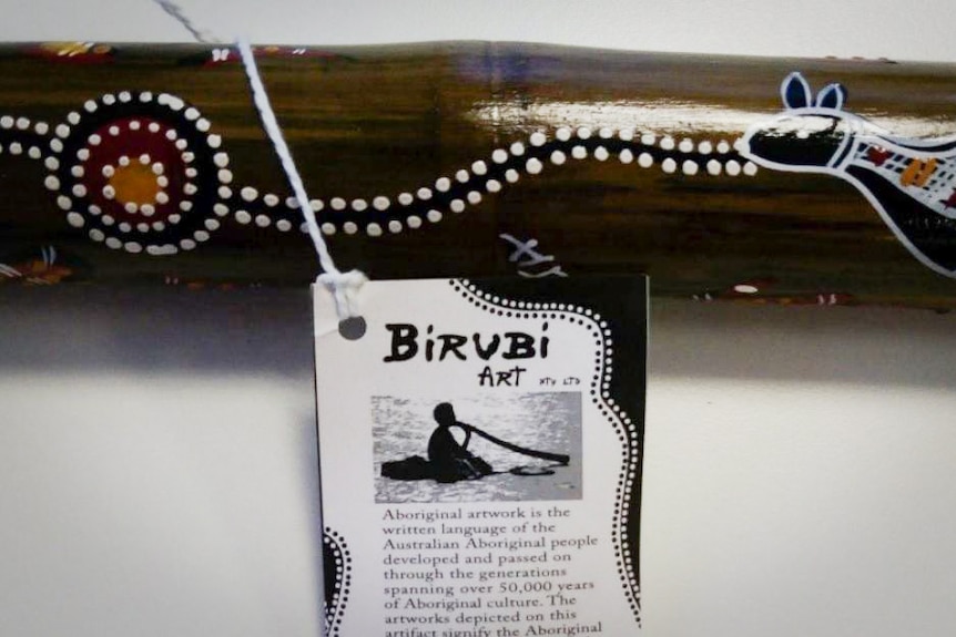 A description tag on a didgeridoo made by Birubi Art.