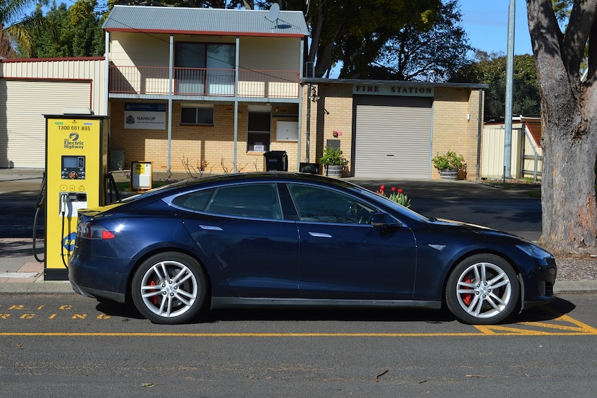 An electric car plugging into a charger outside a home in Nannup.