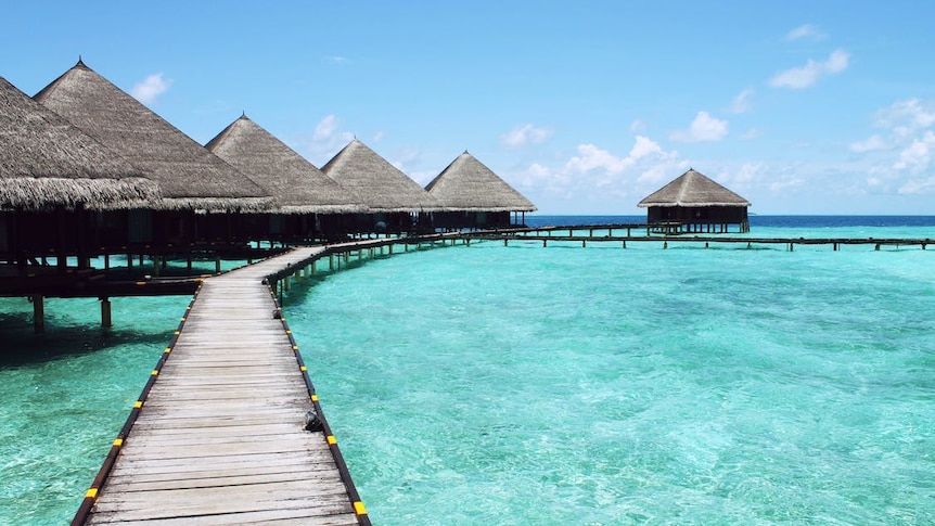 Wooden bungalows on blue ocean