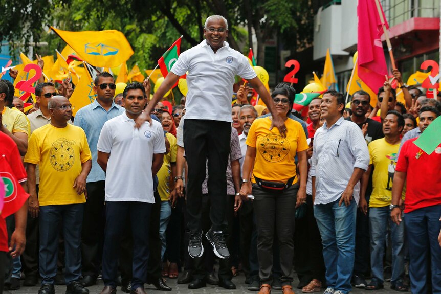 Maldives opposition candidate Ibrahim Mohamed Solih jumps during a rally