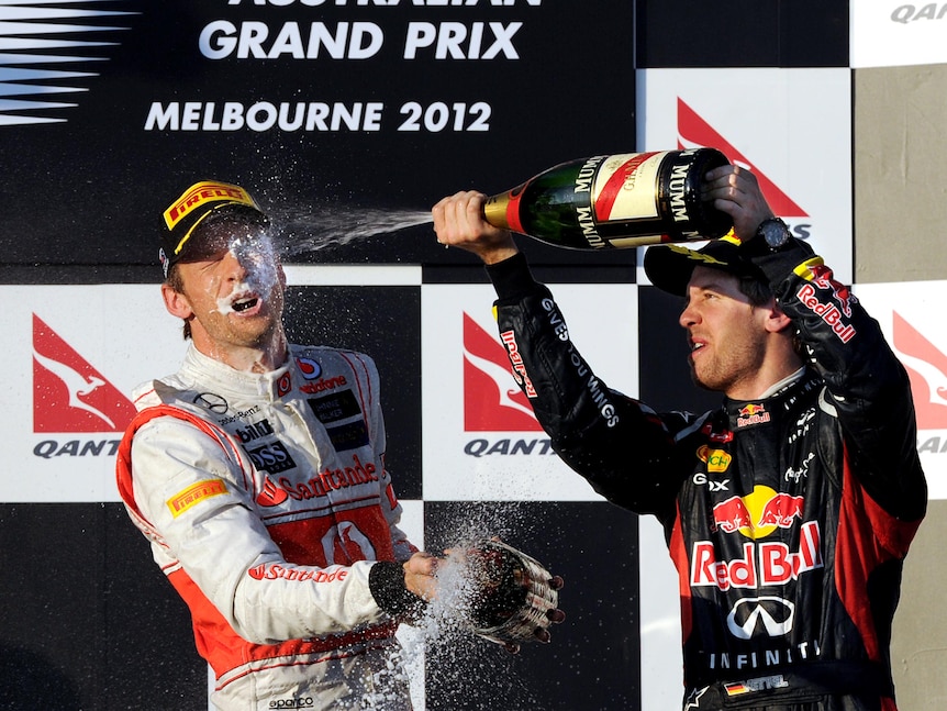 Jenson Button is sprayed by Sebastian Vettel after winning the Australian F1 Grand Prix.