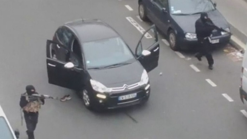 Gunmen flee after opening fire in the offices of Charlie Hebdo in Paris.