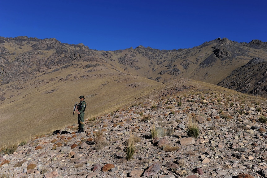 Afghan security guard keeps watch at an iron ore mine