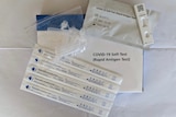 A line of white virus tests some opened and ready to be used.