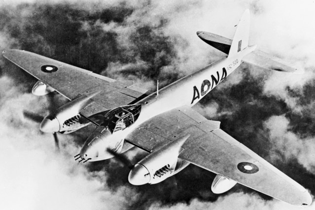 A black and white image of a military plane with two propellers.