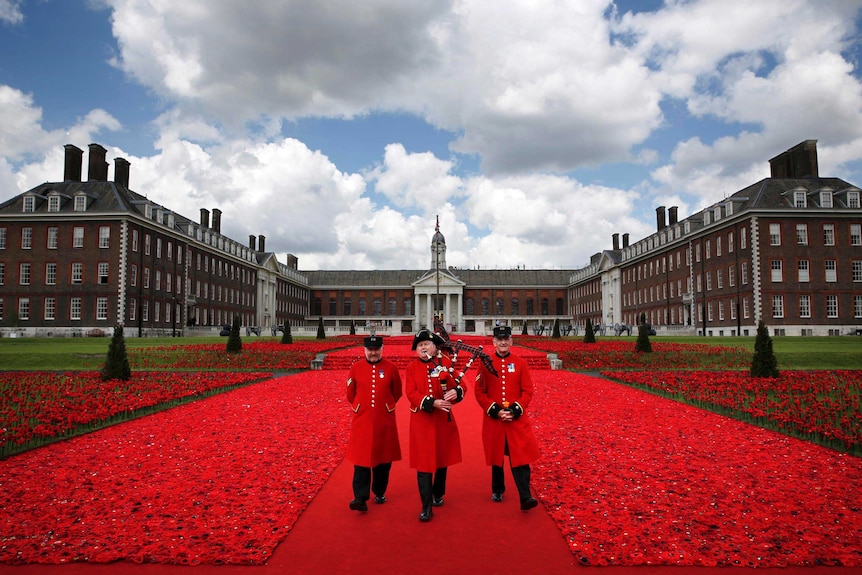 Chelsea Pensioners walk through the 5,000 Poppies Garden.