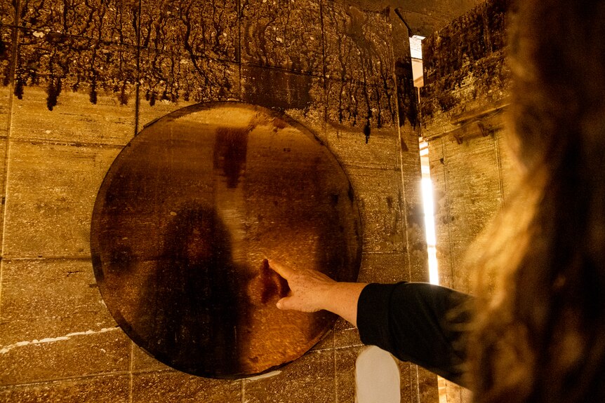 a woman pointing at a mirror