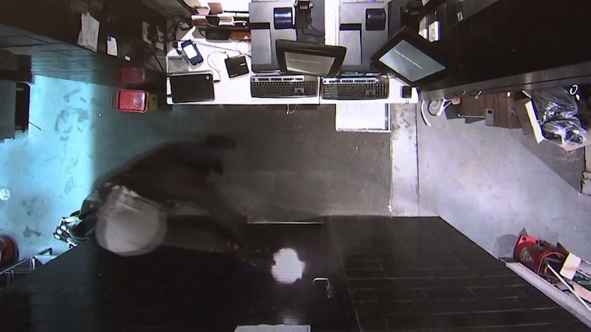 A masked man fired a gun at a door handle at Hotel Queanbeyan.
