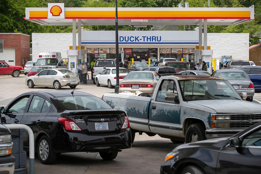 Vehicles are seen queuing at a Shell petrol station 