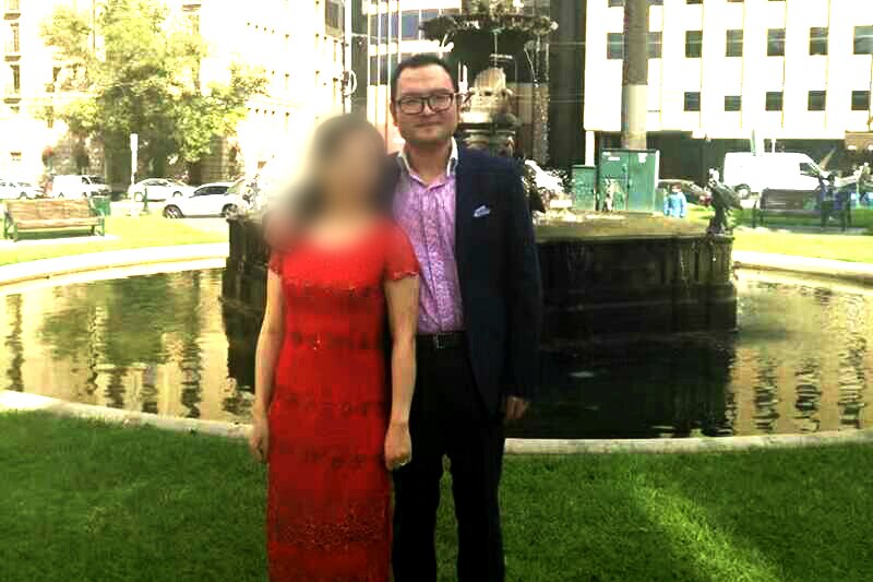 Nick Hao with his wife in front of a fountain in Melbourne.