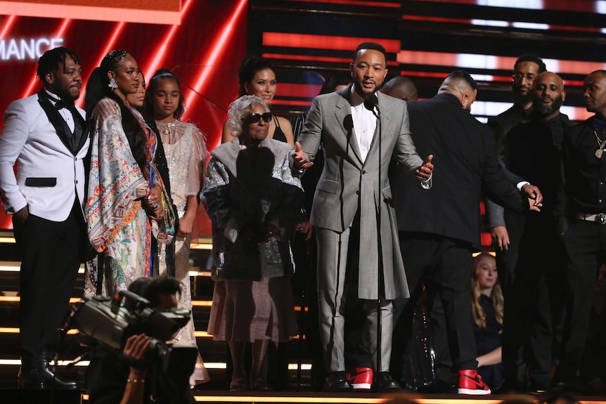 A group of people on the Grammys stage