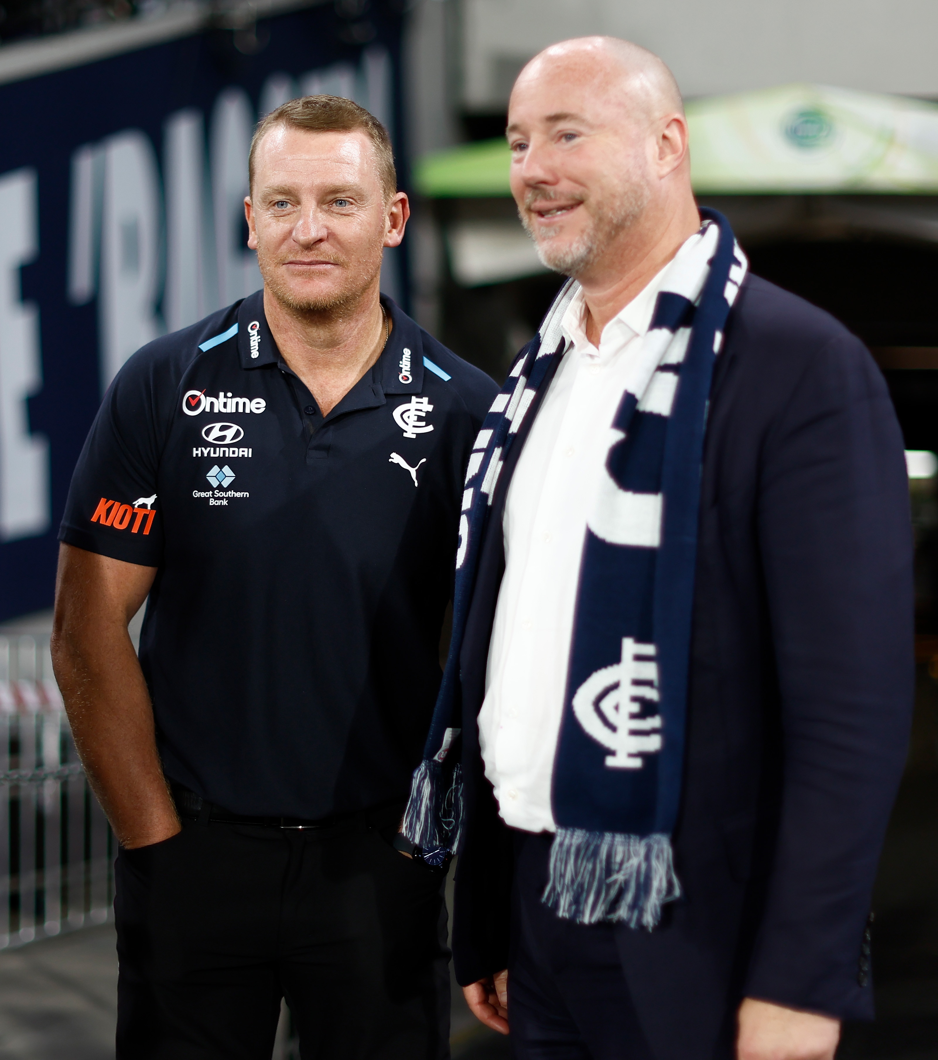 Michael Voss stands next to Luke Sayers