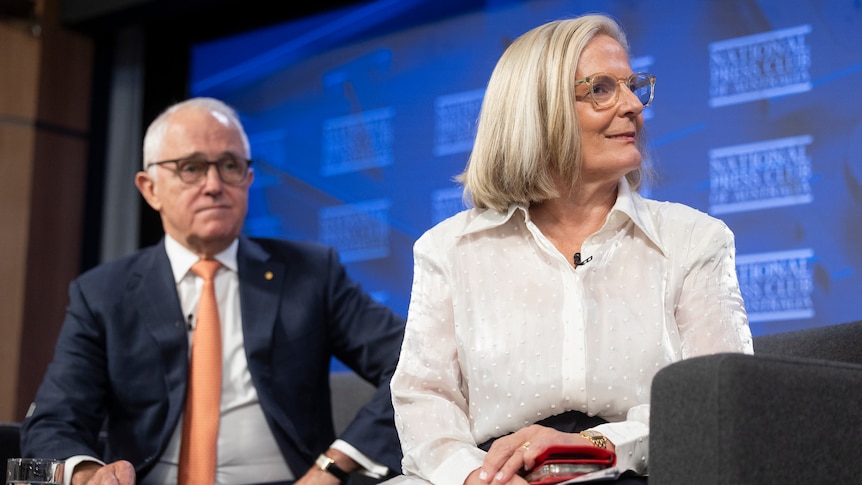 Former prime minster Malcolm Turnbull (left) and wife Lucy Turnbull sit on stage at the National Press Club. 