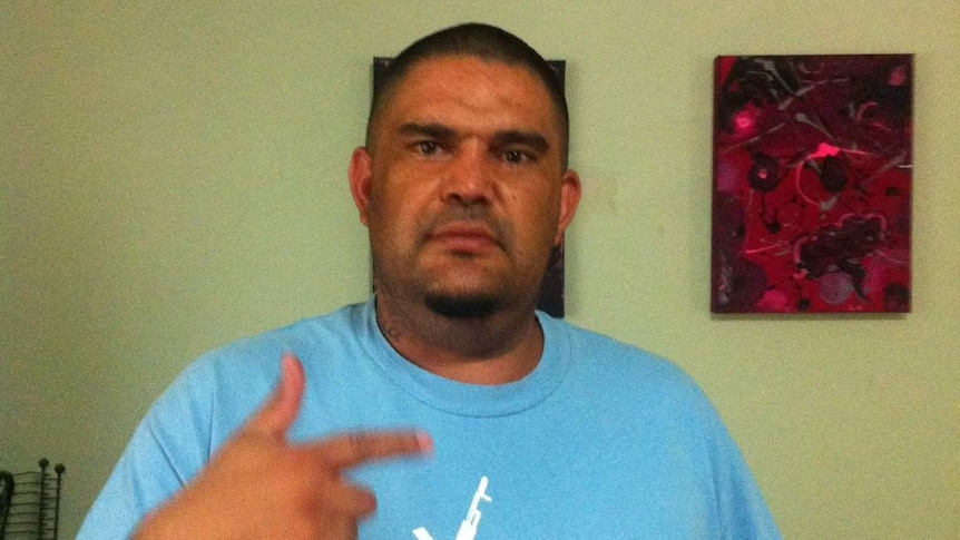 A man wearing a blue t-shirt.