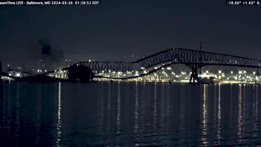 A scene late at night of a bridge mid collapsing.