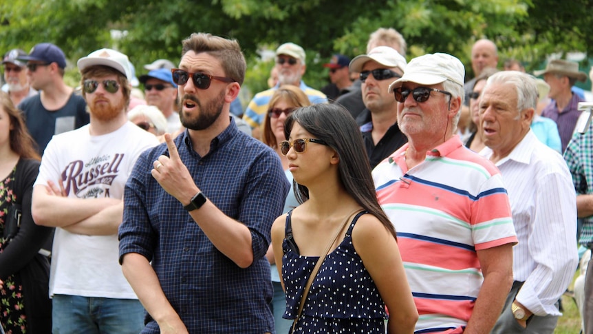 A young couple make a bid on land in Hobart