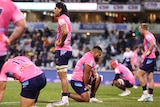 Melbourne Rebels players look sad during a Super Rugby game.