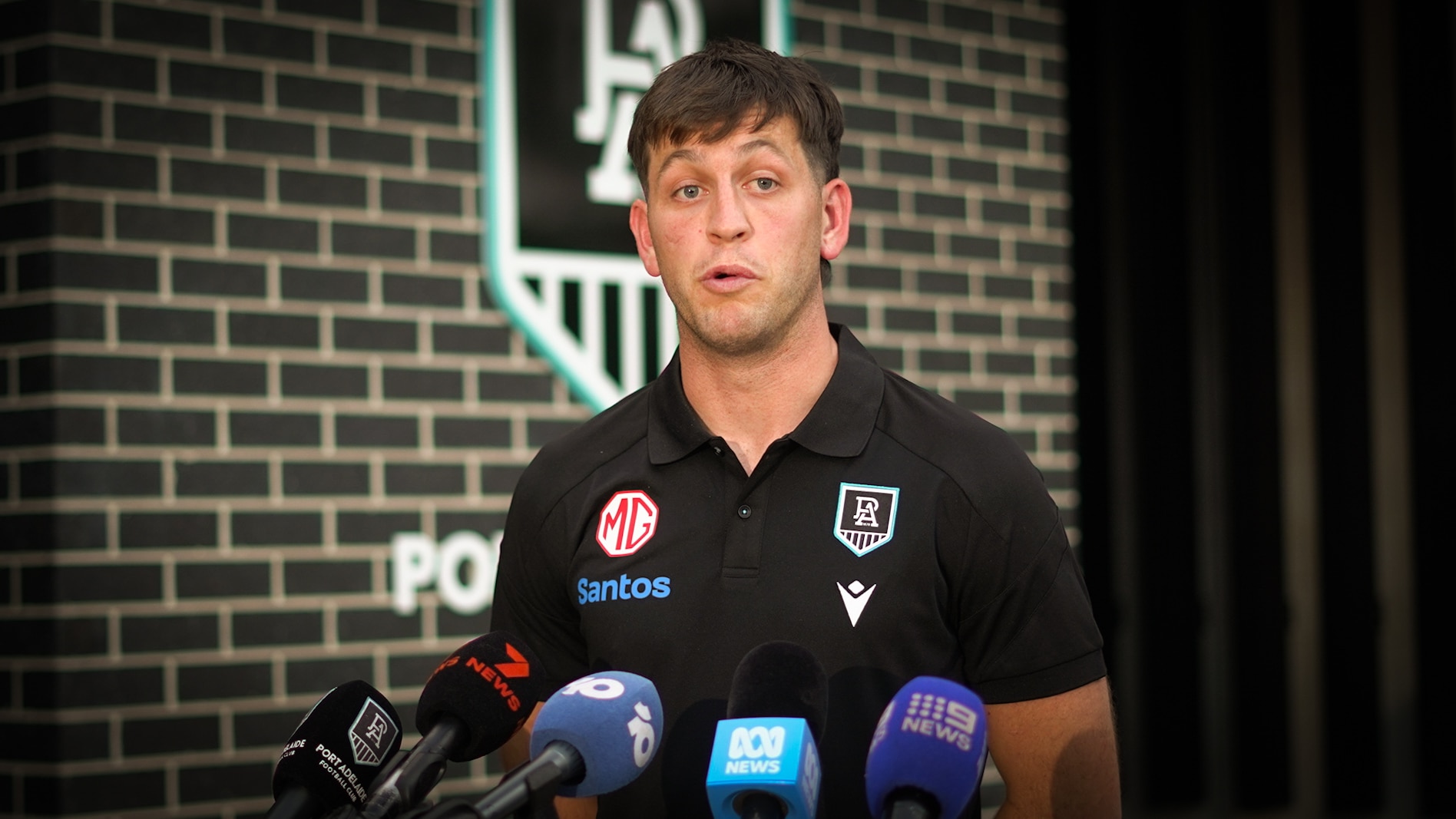 Zak Butters speaks into microphones