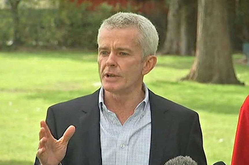 Senator Malcolm Roberts addresses microphones at a press call.