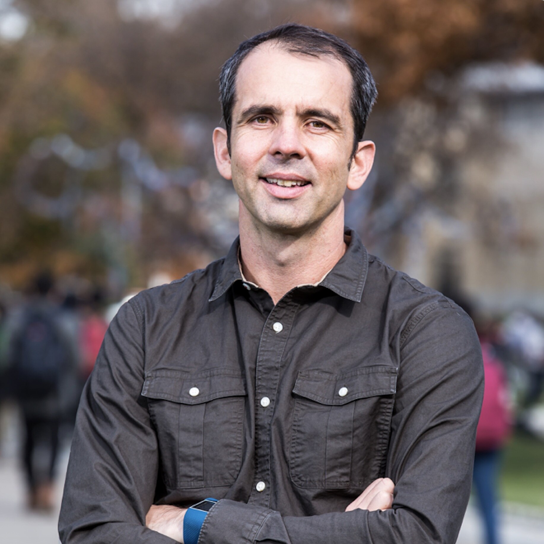 Headshot of Prof Simon Lucey, who is staring at the camera wearing a brown shirt.