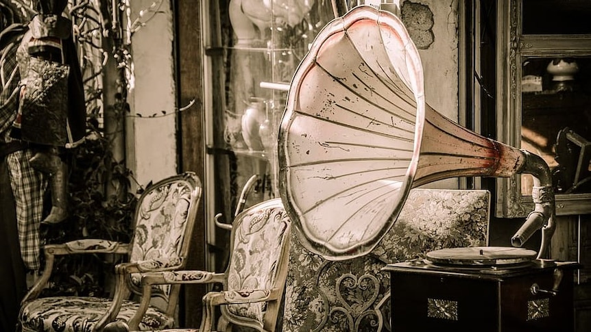 A gramophone sits in an old drawing room