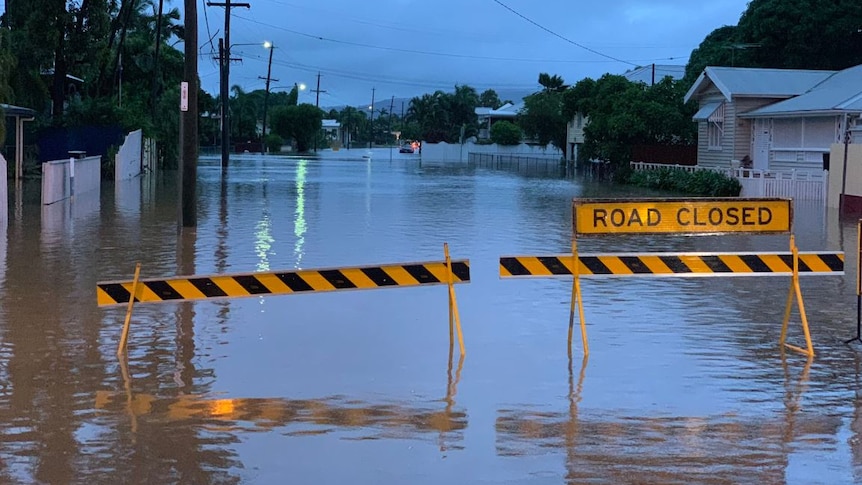 A flooded street with a 'Road Closed' sign in the Townsville suburb of Railway Estate.