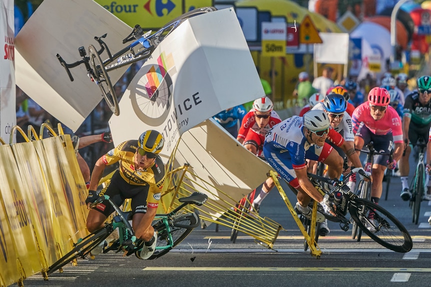 A cyclist crashes meters before the finish line, after colliding with fellow riders.