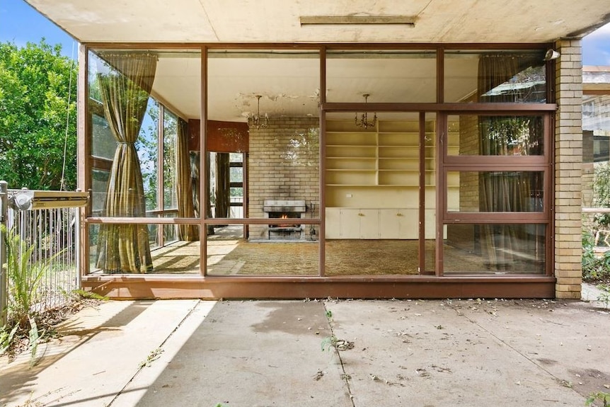 Floor to ceiling windows feature in the living room of Gough Whitlam's former home.