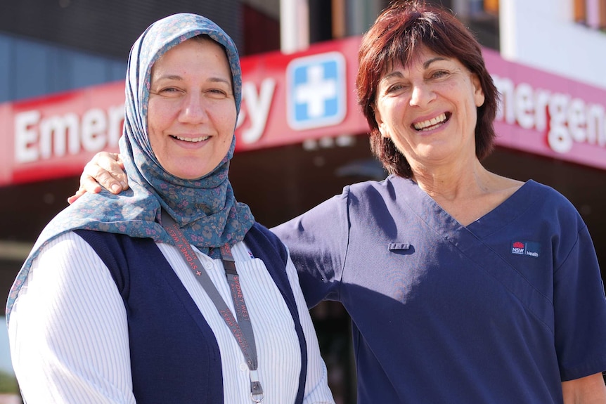 Blacktown Hospital health workers Nawal Nadar and Terry Leathers stand outside the emergency department.