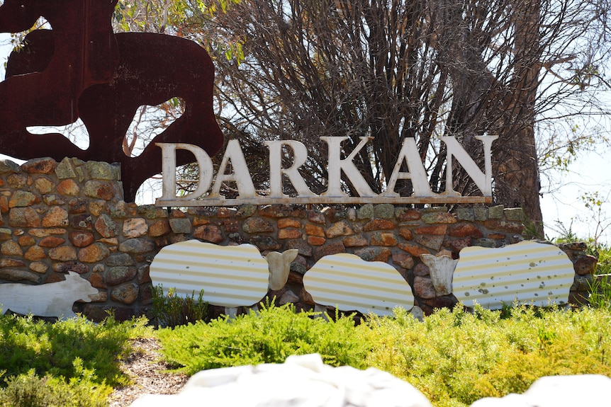 Letters reading Darkan installed on top of a stone wall 