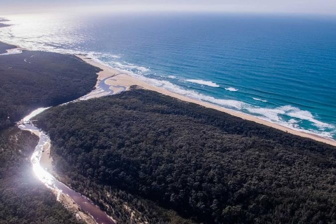 an aerial view of an inlet leading to the ocean