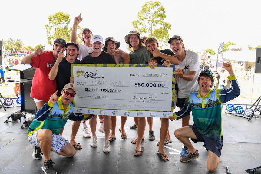 A group cheers with a big cheque