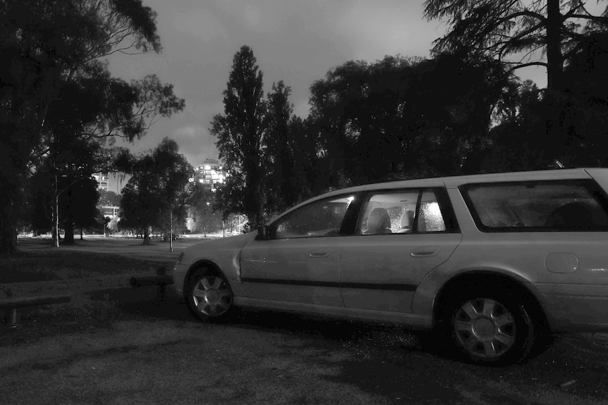 Black and white photo of car in Telopea Park at night.