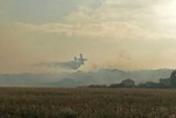 Aerial efforts have controlled the bushfire burning since last Tuesday