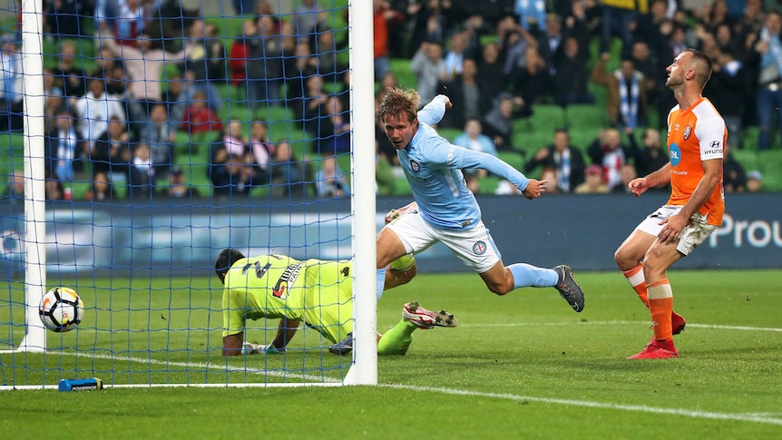 Nick Fitzgerald of Melbourne City scores, goldie dives for ball.