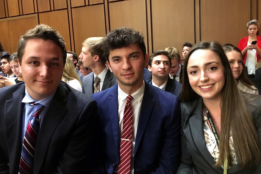 A photo of three interns sitting in the room where James Comey testified.