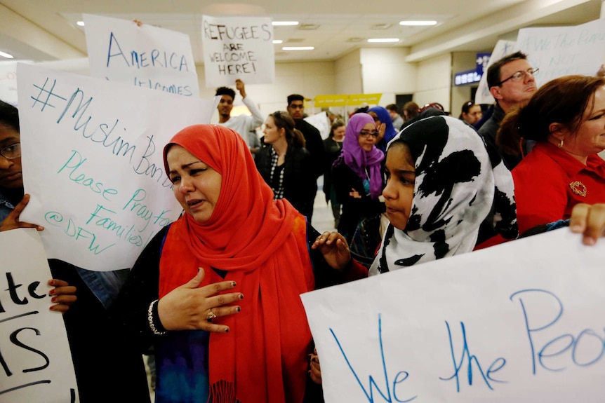 protesters and family gather at Dallas fort worth airport