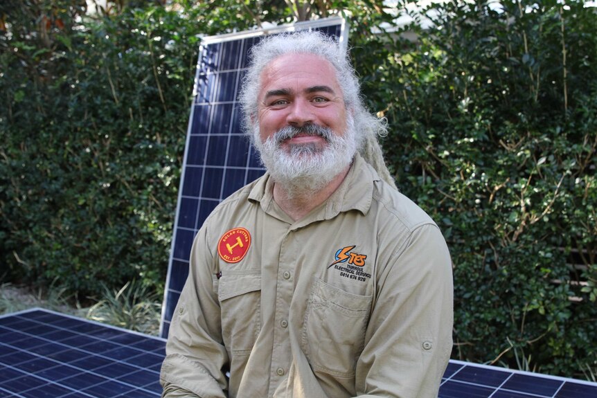 Johann Fleury in front of solar panels