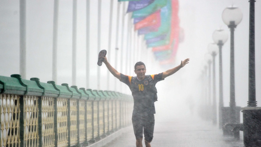 Pedestrians run, trying to escape the heavy rain in Sydney