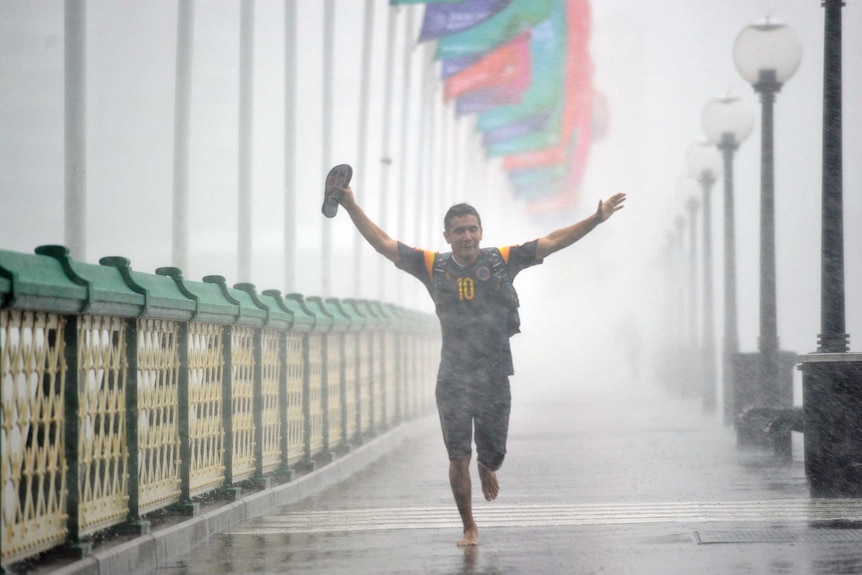 Pedestrians run, trying to escape the heavy rain in Sydney