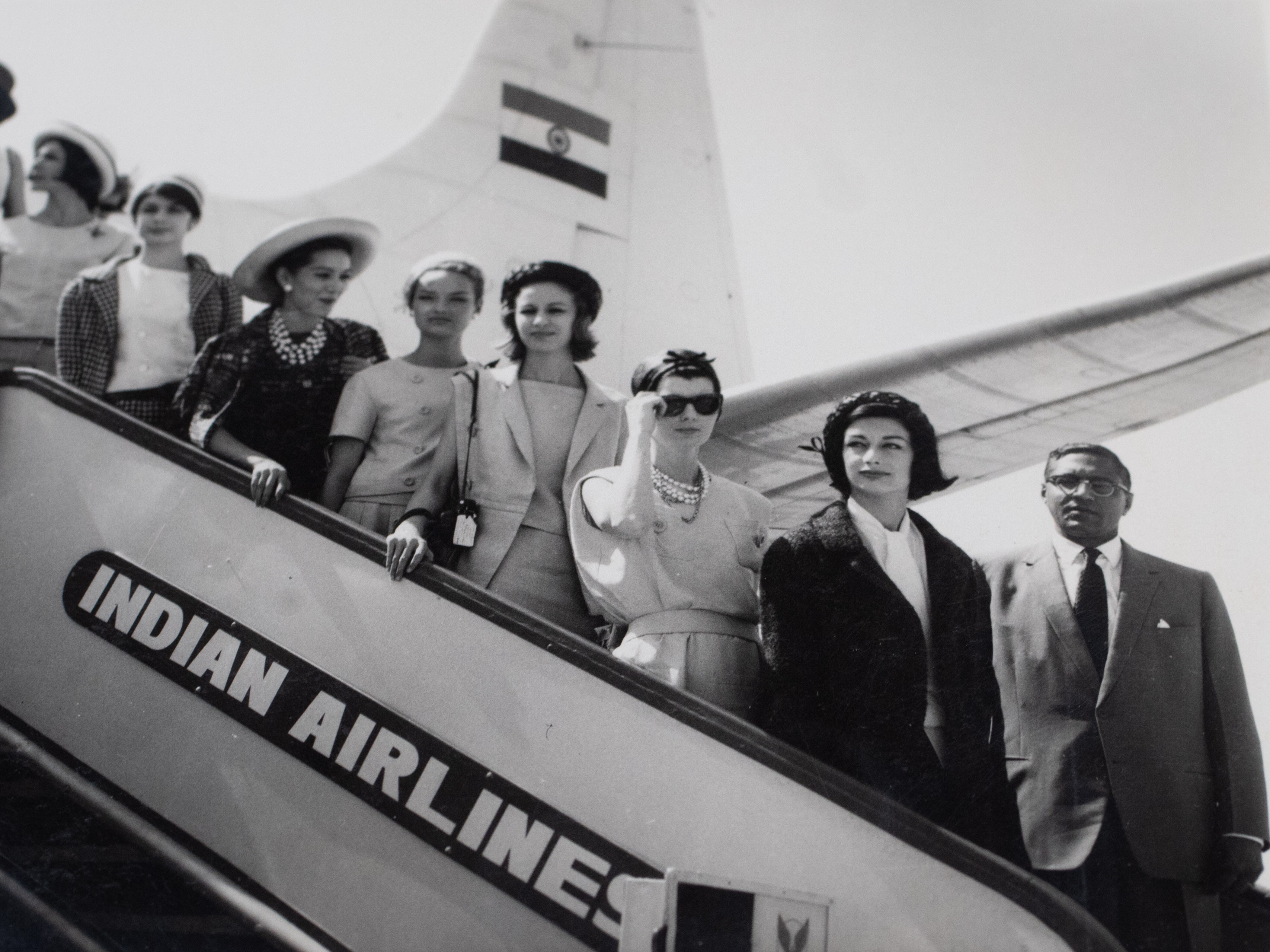 Gay Welsh poses for a photo with others, on the&nbsp;staircase of an Indian Airline plane.&nbsp;