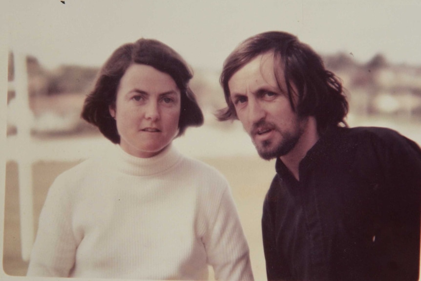 An old photo of a woman and a man posing for the camera, around the 1970s or 80s.