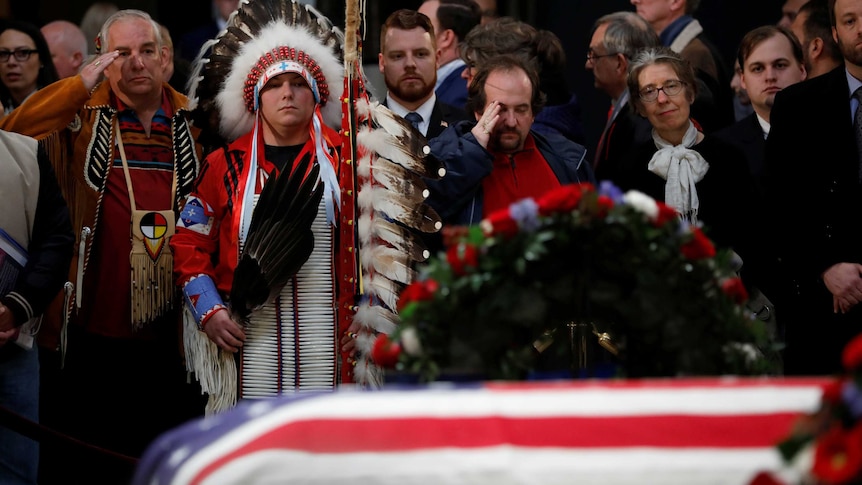Mourners pay their respects at the casket of former US president George HW Bush as it lies in state.