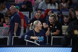 Lauren Jackson sits with a pair of crutches