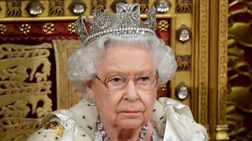 Queen Elizabeth and Prince Charles sitting in the House of Lords.